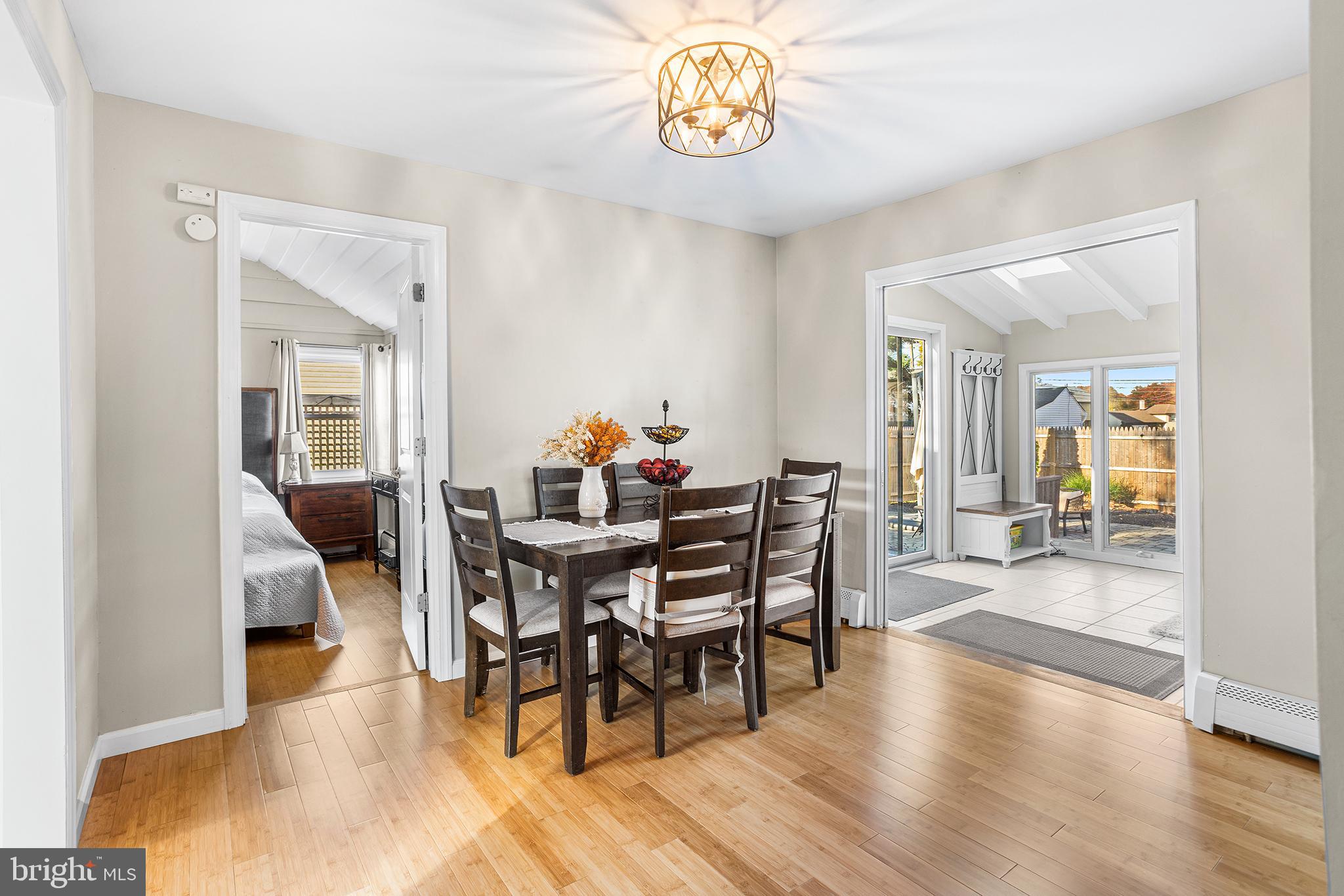 48 Falmouth Road Hamilton, NJ 08620 - Photo 9 of 34 a view of a dining room and livingroom with furniture wooden floor a chandelier