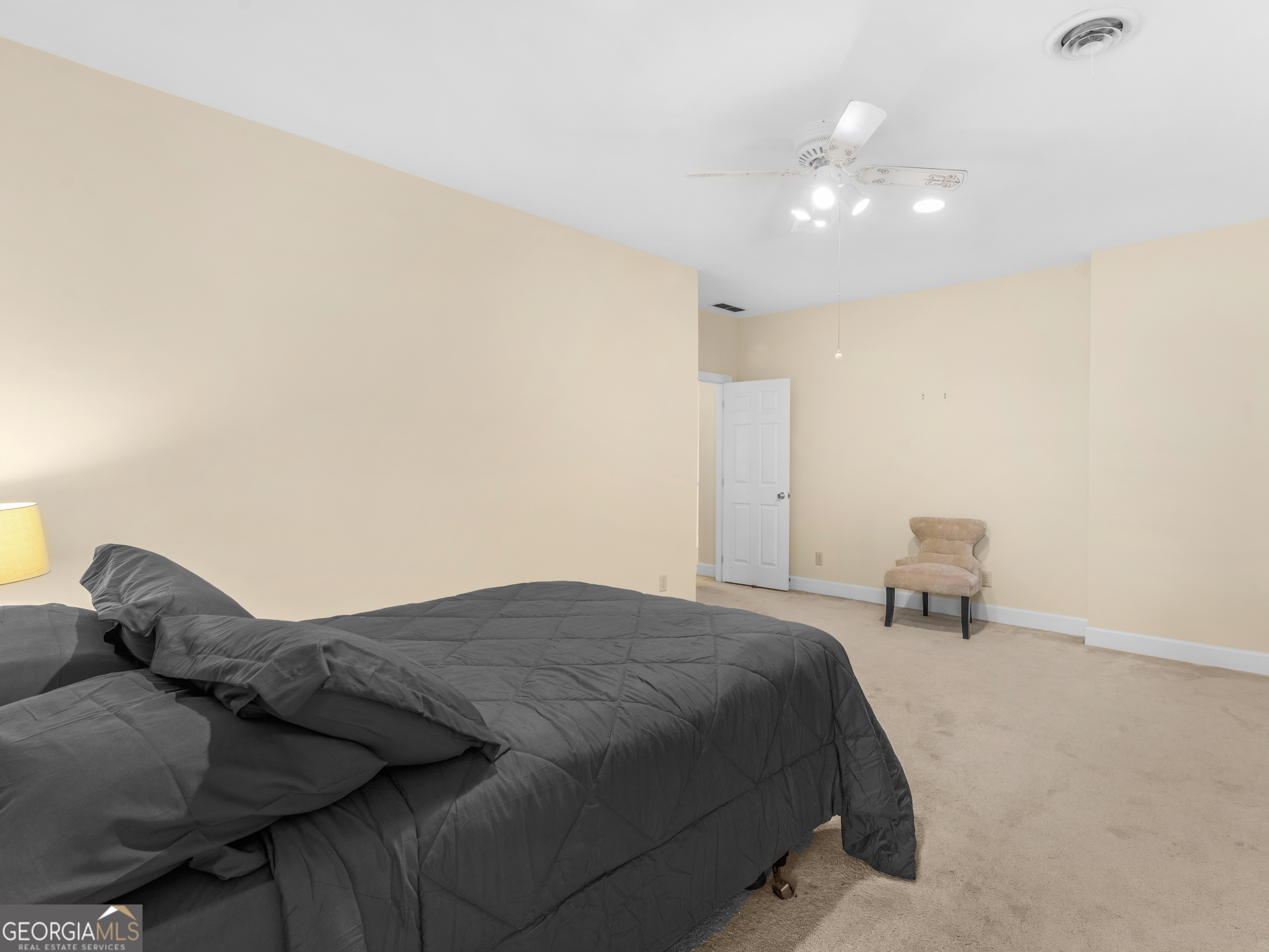 474 North Rover Road Williamson, GA 30292 - Photo 64 of 89 a bedroom with a bed and a lamp with window