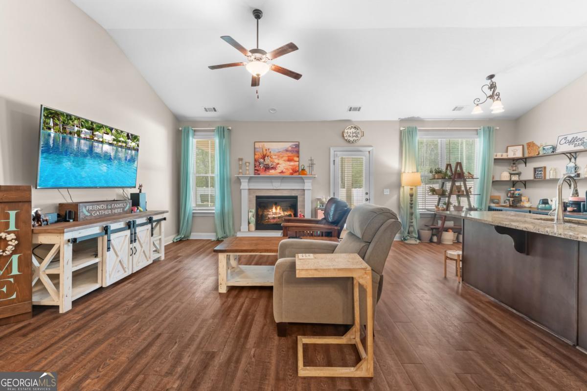161 Laguna Way Savannah, GA 31405 - Photo 11 of 33 a living room with fireplace furniture and a flat screen tv
