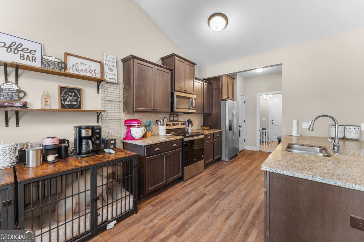 161 Laguna Way Savannah, GA 31405 - Photo 15 of 33 a kitchen with granite countertop a sink cabinets and stainless steel appliances