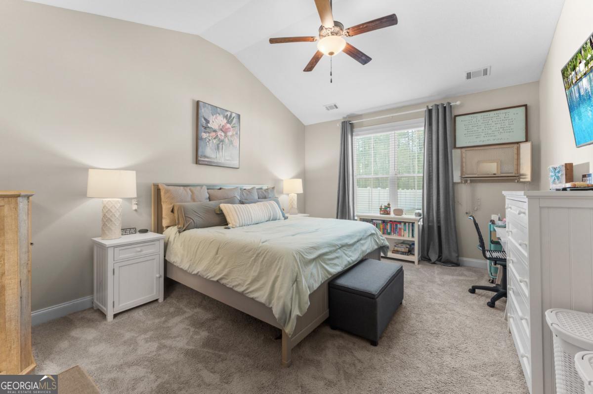 161 Laguna Way Savannah, GA 31405 - Photo 18 of 33 a bedroom with a bed and a chandelier