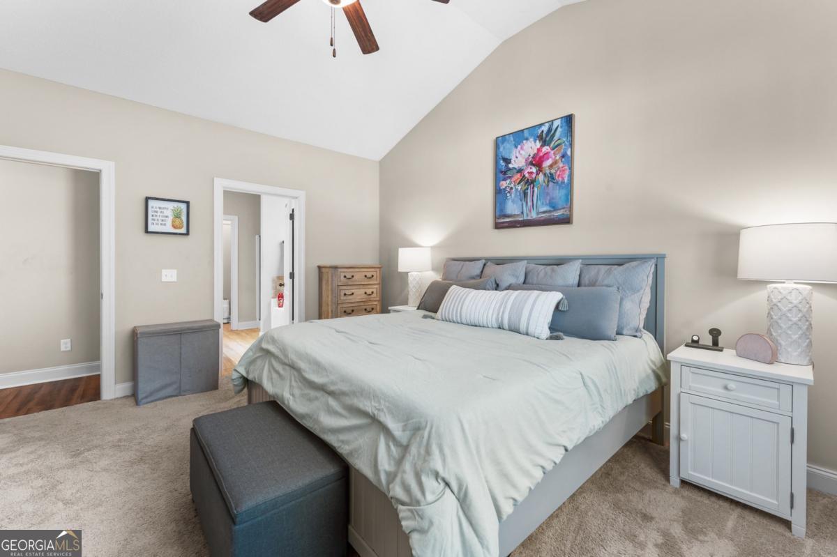 161 Laguna Way Savannah, GA 31405 - Photo 19 of 33 a bedroom with a bed and a chandelier