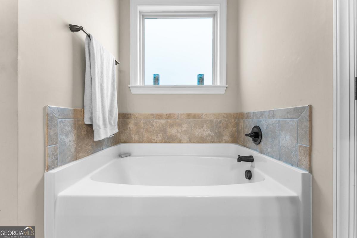 161 Laguna Way Savannah, GA 31405 - Photo 20 of 33 a white bath tub sitting in a bathroom