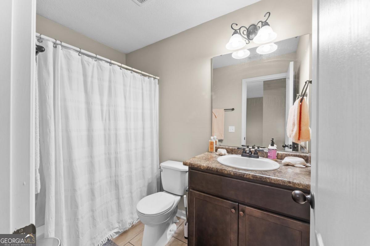 161 Laguna Way Savannah, GA 31405 - Photo 25 of 33 a bathroom with a sink vanity mirror and toilet
