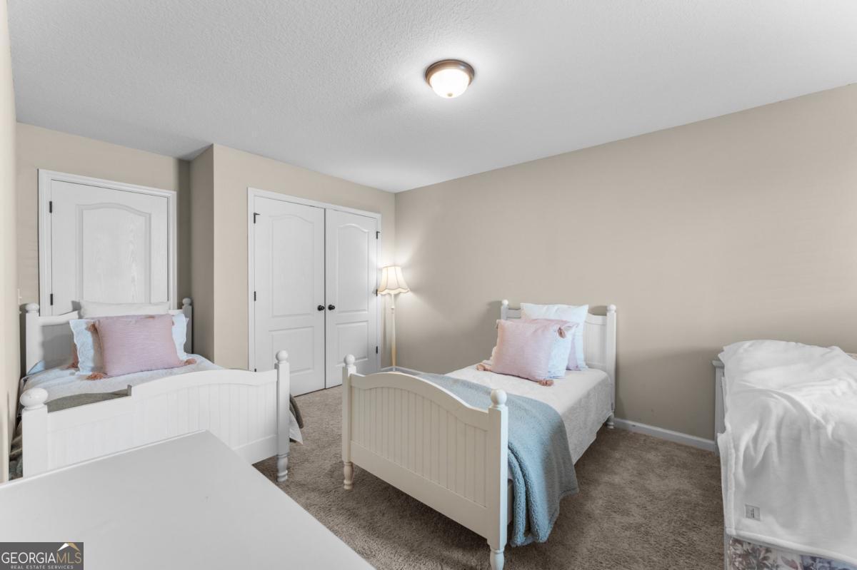 161 Laguna Way Savannah, GA 31405 - Photo 27 of 33 a bedroom with a bed and a lamp