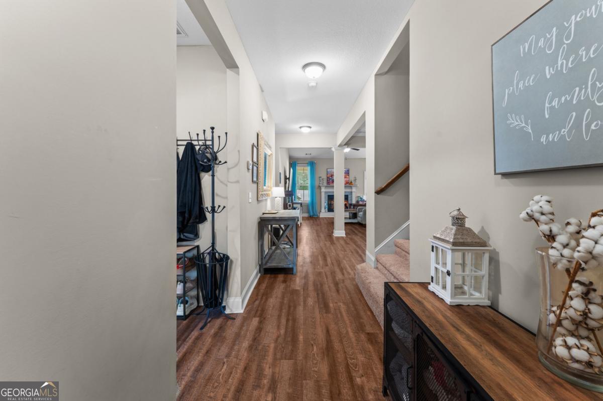 161 Laguna Way Savannah, GA 31405 - Photo 4 of 33 a view of a hallway with furniture and wooden floor
