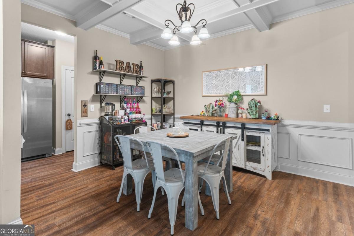 161 Laguna Way Savannah, GA 31405 - Photo 10 of 33 a view of a dining room and a kitchen with a table chairs