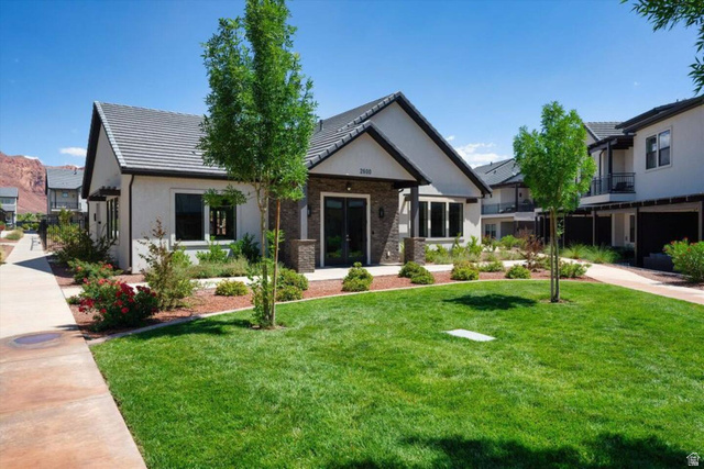 2600 Ocotillo Way, Unit 56 Santa Clara, UT 84765 - Photo 33 of 33 CLUB HOUSE: View of front facade featuring a front yard, stucco siding, brick siding, and a tile roof