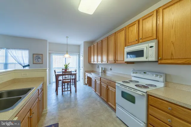 a kitchen with a stove a sink and a microwave