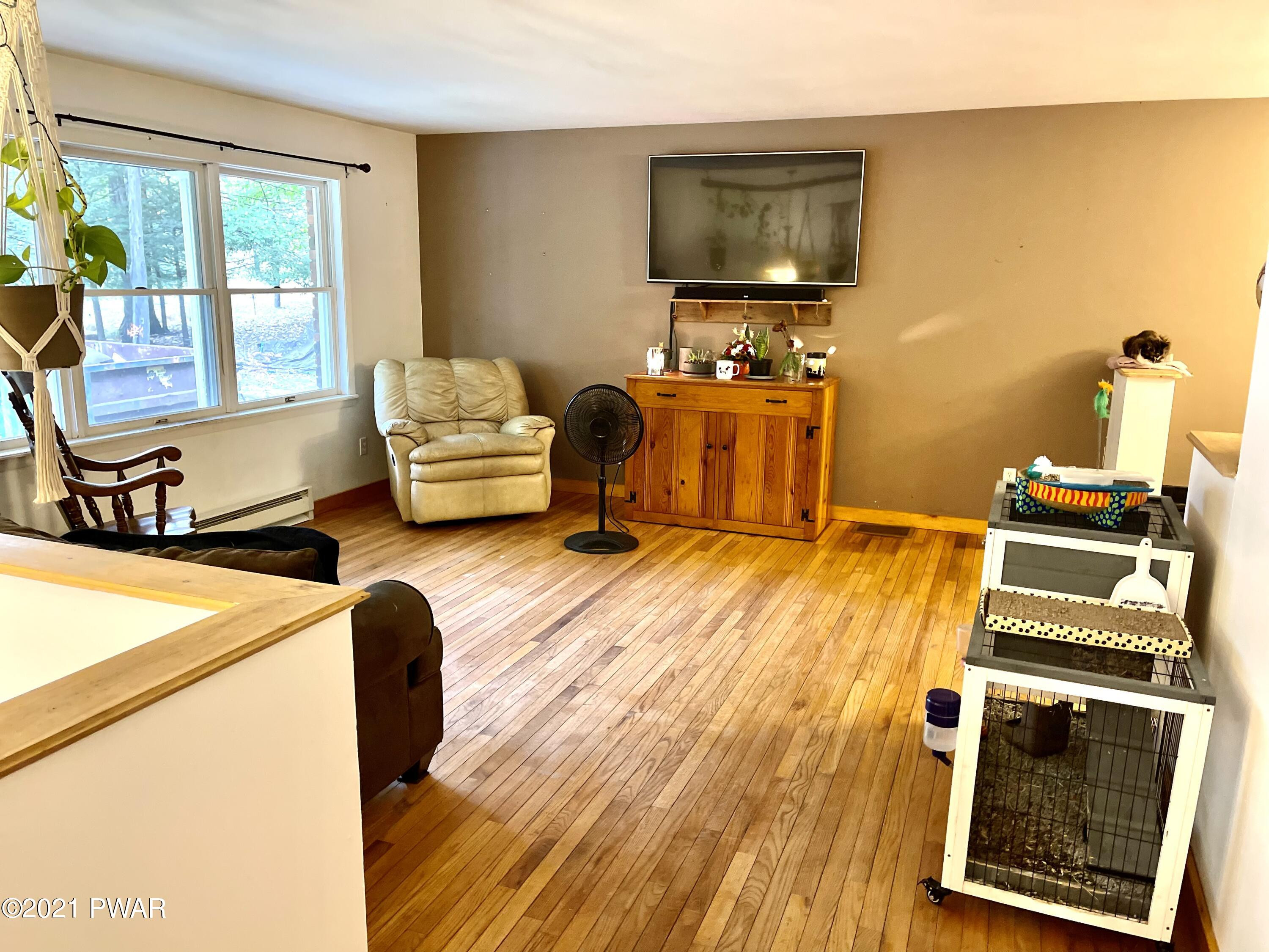 127 Estates Road Greentown, PA 18426 - Photo 66 of 85 a living room with a couch and a flat screen tv