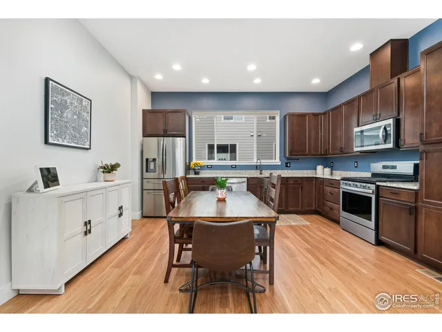 a kitchen with stainless steel appliances kitchen island granite countertop a kitchen island hardwood floor sink and stove