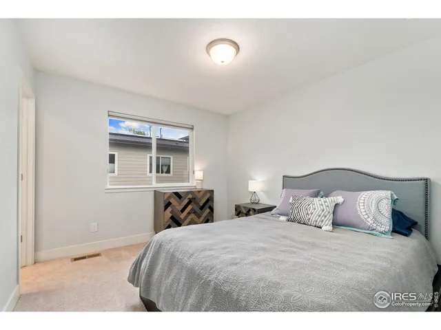 a bedroom with a bed and a night stand