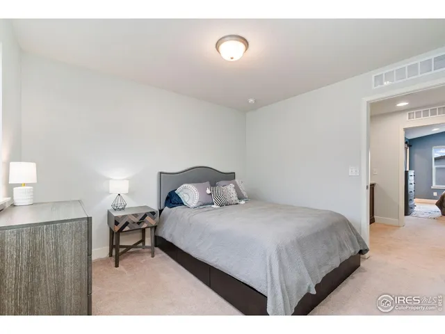 a bedroom with a bed and a night stand