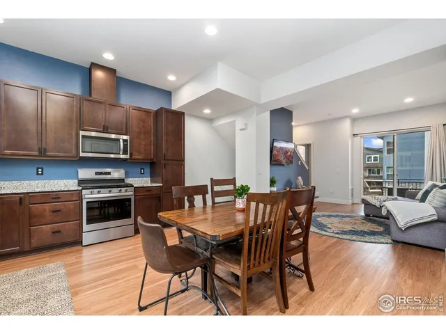 a kitchen with stainless steel appliances kitchen island granite countertop a kitchen island hardwood floor sink and stove