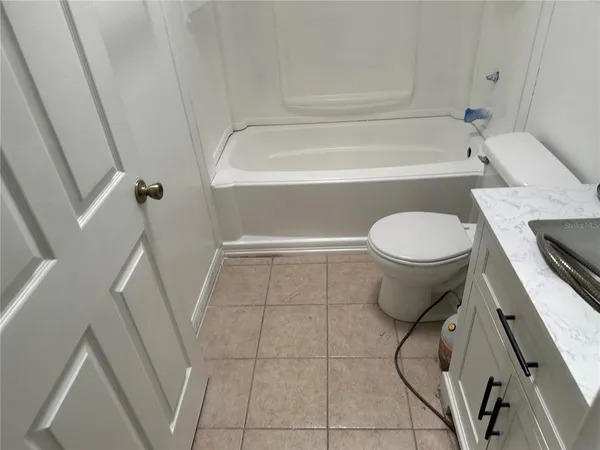 a bathroom with a toilet a sink and bathtub