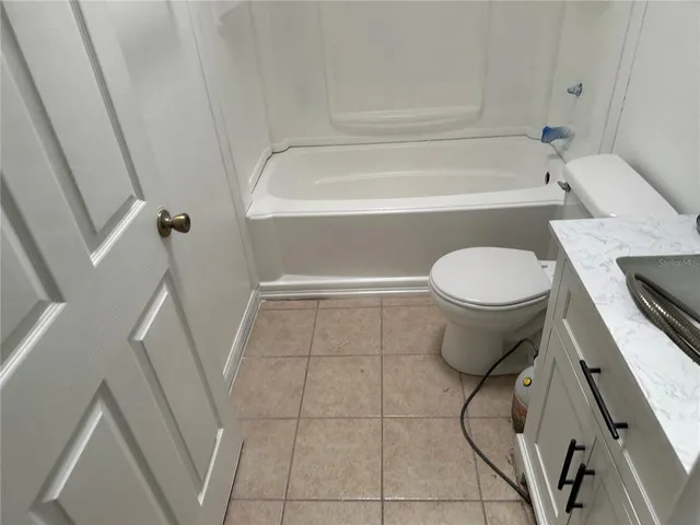 a bathroom with a toilet a sink and bathtub