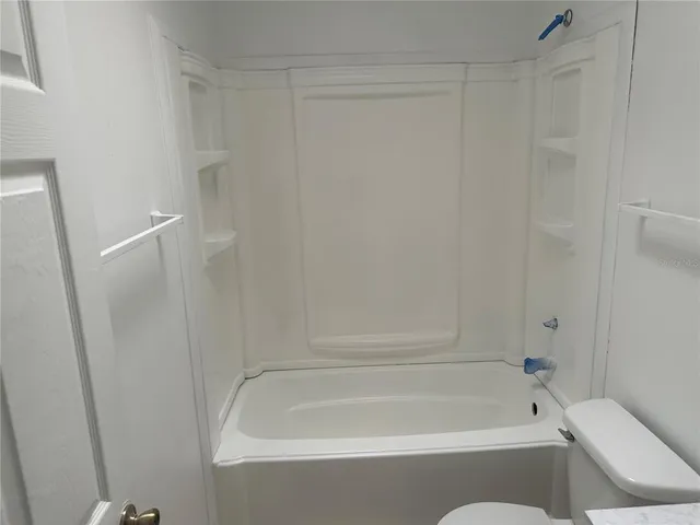 a bathroom with a bathtub and shower