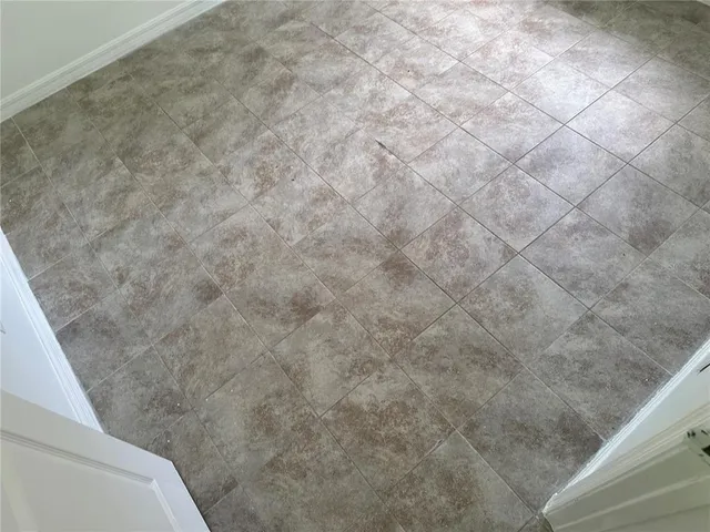 a room with granite countertop a sink and a window