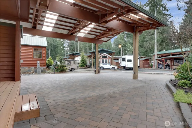 a view of a patio with table and chairs under an umbrella