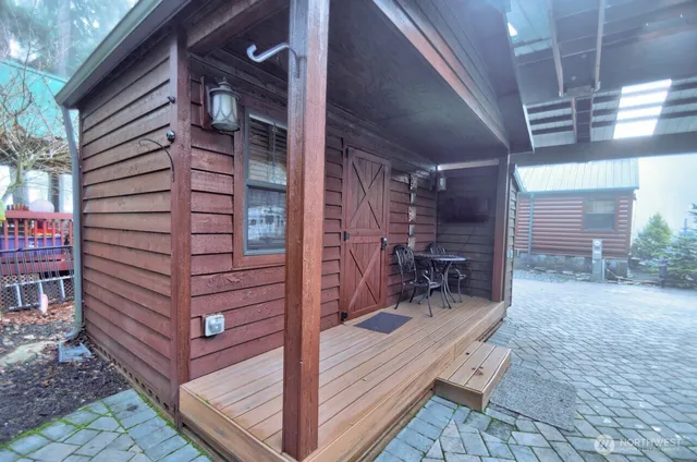 a backyard of a house with table and chairs