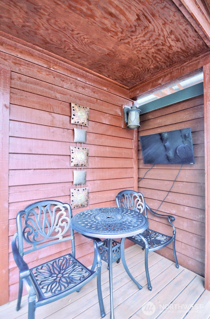 1546 Reservation Road Southeast, Unit 248 Olympia, WA 98513 - Photo 7 of 29 a backyard of a house with table and chairs