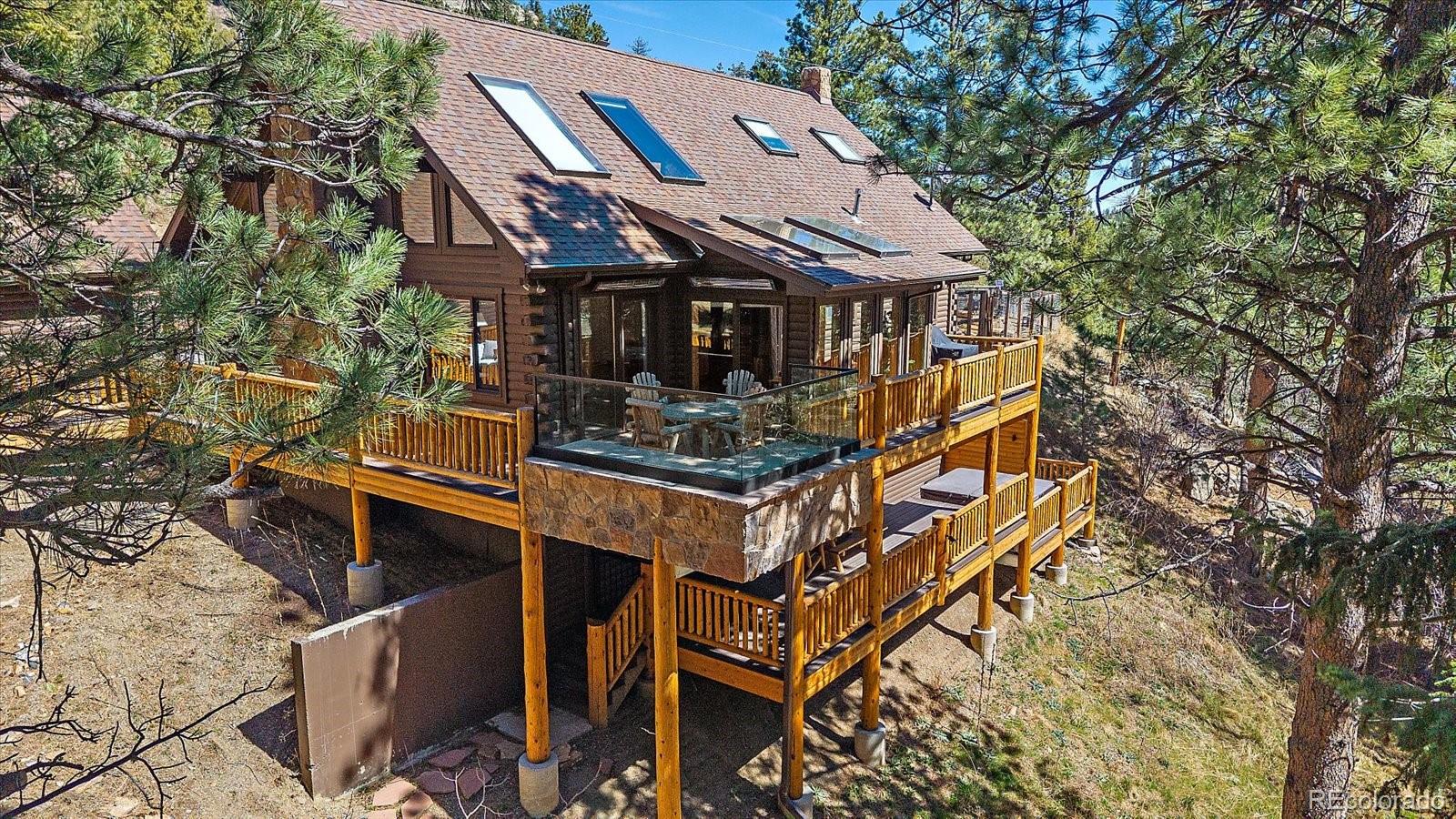 1385 Beaver Brook Canyon Road Evergreen, CO 80439 - Photo 34 of 49 a front view of a house with a yard