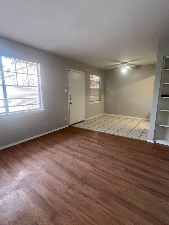 307 East 31st Street, Unit 208 Austin, TX 78705 - Photo 12 of 25 an empty room with wooden floor and windows