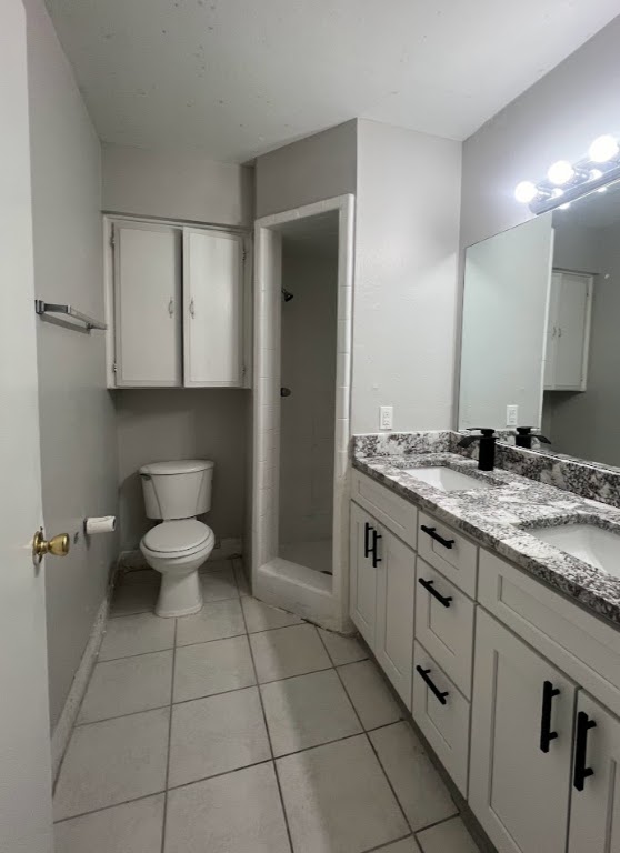 307 East 31st Street, Unit 208 Austin, TX 78705 - Photo 16 of 25 a bathroom with a granite countertop sink and a toilet