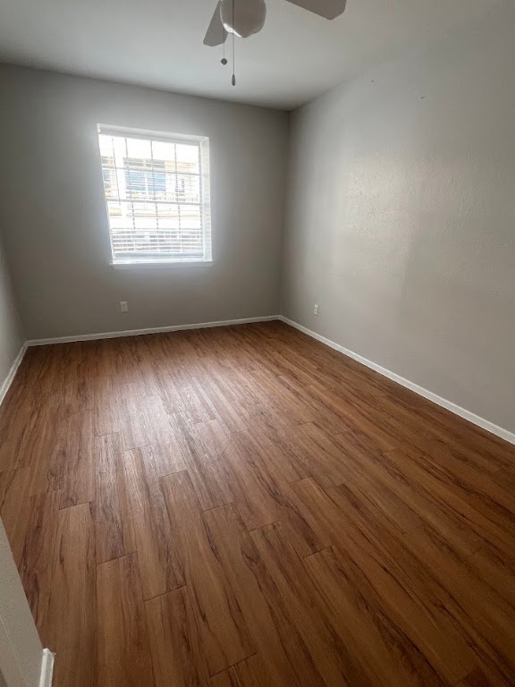 307 East 31st Street, Unit 208 Austin, TX 78705 - Photo 18 of 25 an empty room with wooden floor and windows