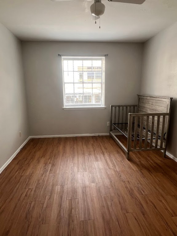 307 East 31st Street, Unit 208 Austin, TX 78705 - Photo 24 of 25 an empty room with wooden floor and windows