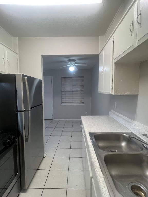 307 East 31st Street, Unit 208 Austin, TX 78705 - Photo 9 of 25 a kitchen with a sink a refrigerator and cabinets