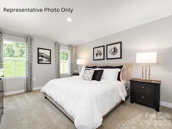 a spacious bedroom with a bed and a window