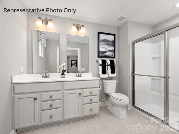a spacious bathroom with a granite countertop sink mirror and toilet