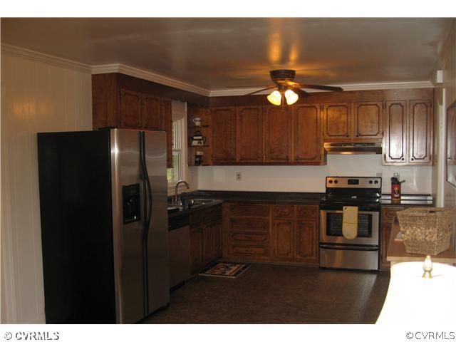 11238 Hanover Courthouse Road Mechanicsville, VA 23116 - Photo 2 of 12 a kitchen with a refrigerator and a sink