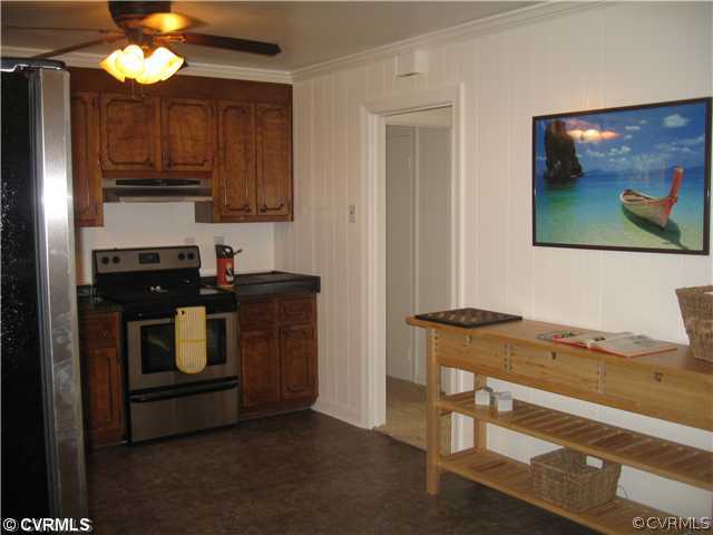 11238 Hanover Courthouse Road Mechanicsville, VA 23116 - Photo 5 of 12 a kitchen with stainless steel appliances granite countertop a stove a sink and a microwave