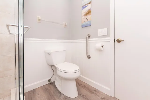 a bathroom with a toilet and a shower