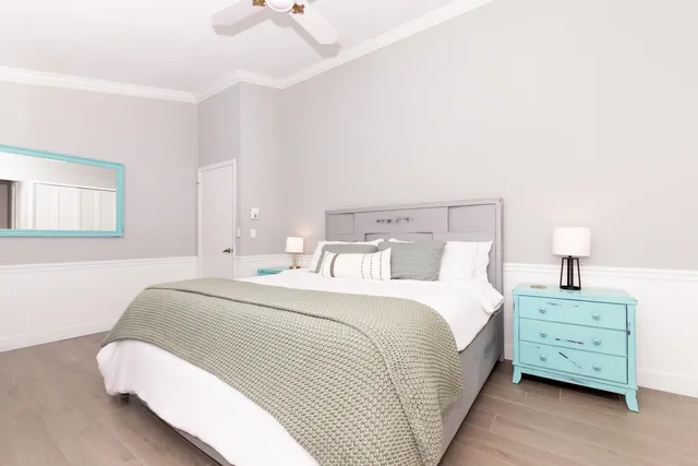 a bedroom with a bed and a night stand