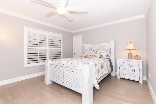 a bedroom with a bed dresser and a window
