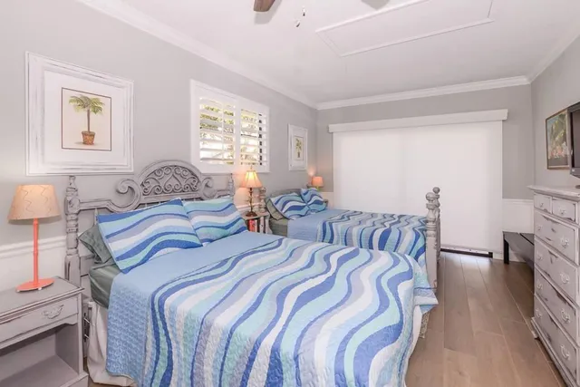 a bedroom with two beds and a night stand