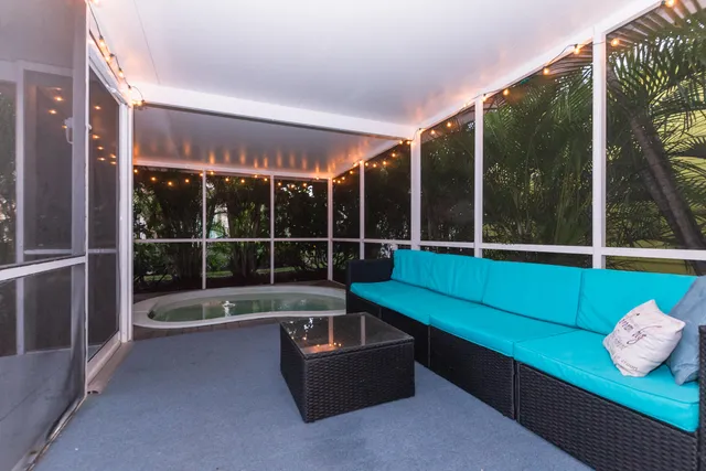 a view of a chairs and table in the balcony
