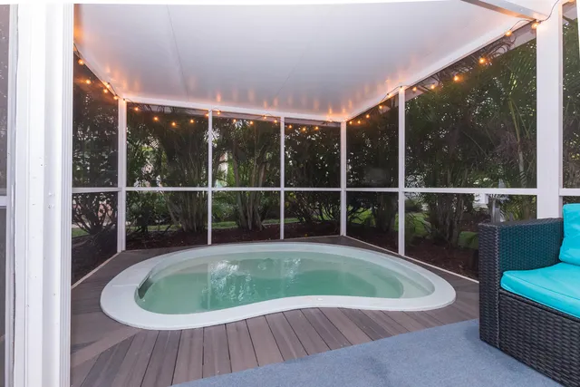 a view of a house with pool and wooden floor