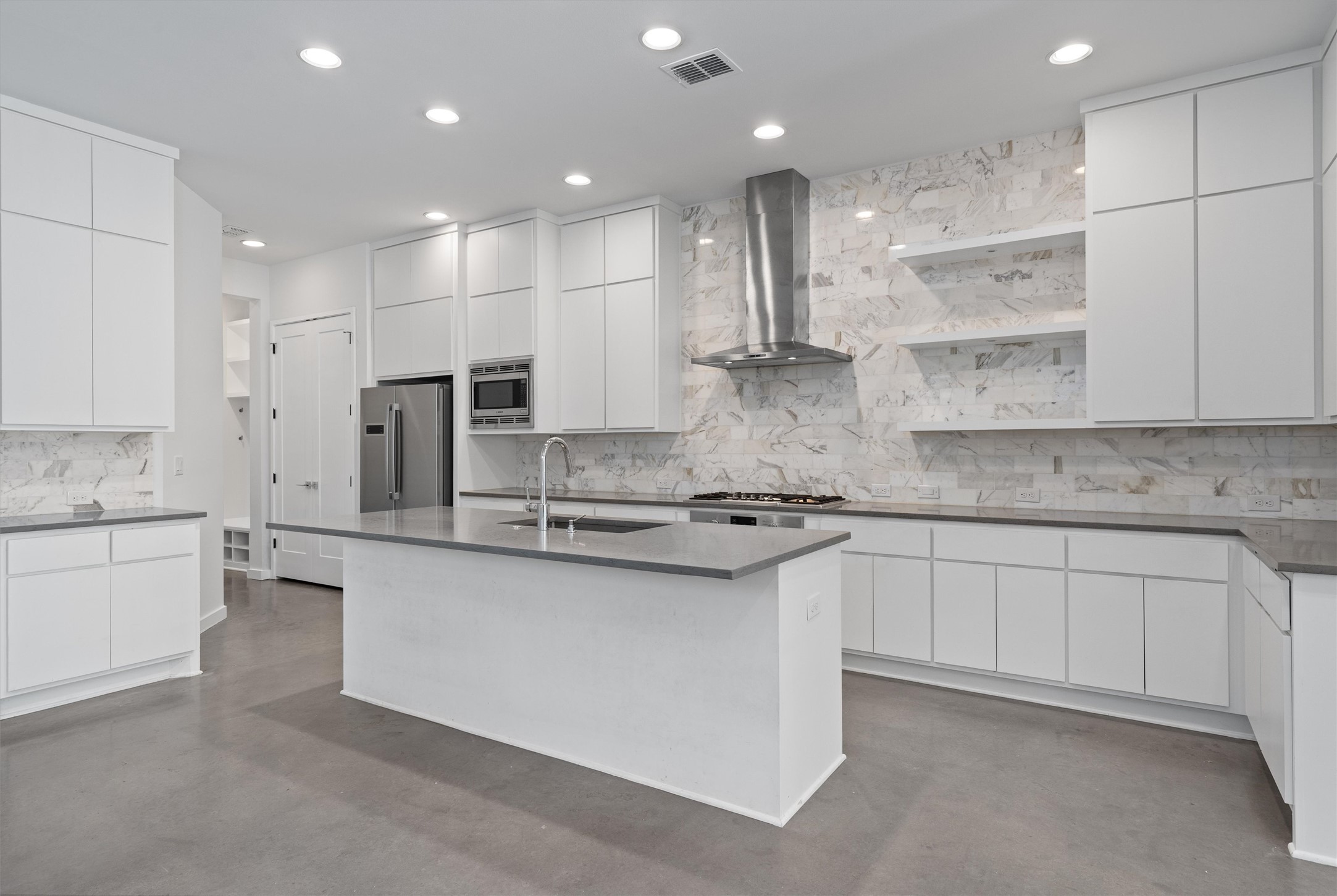1107 Taulbee Lane, Unit B Austin, TX 78757 - Photo 3 of 37 Large kitchen with island, Bosch appliances, Calacattta marble backsplash