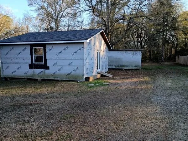a view of backyard with large trees