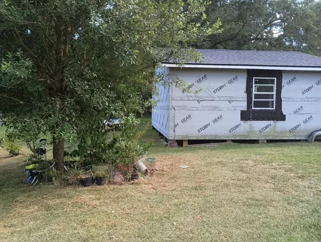 a view of a barn in the patio with a yard