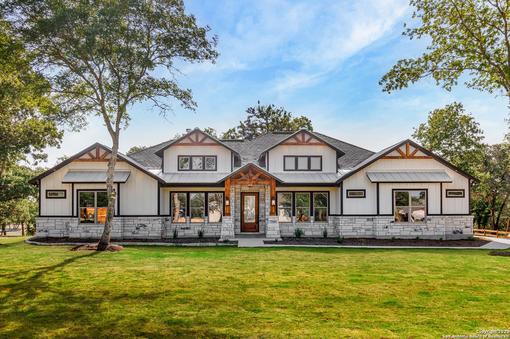 a front view of a house with swimming pool having outdoor seating