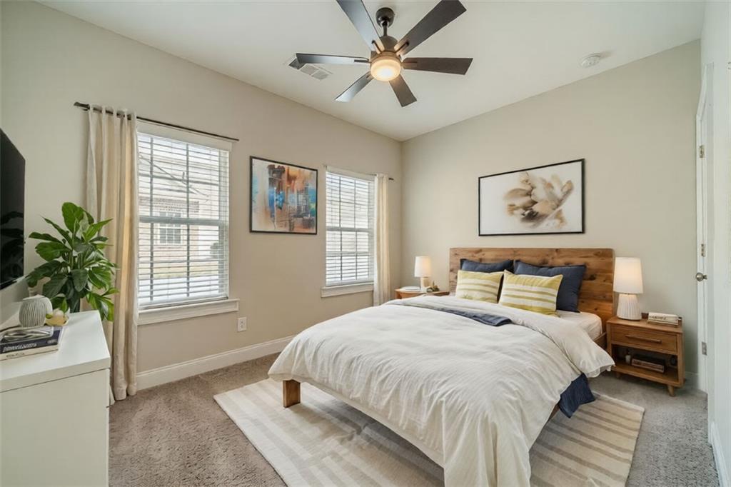 347 Villa Park Circle Stone Mountain, GA 30087 - Photo 17 of 25 a bedroom with a large bed chandelier and a window