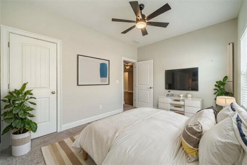 347 Villa Park Circle Stone Mountain, GA 30087 - Photo 19 of 25 a bedroom with a bed and a potted plant