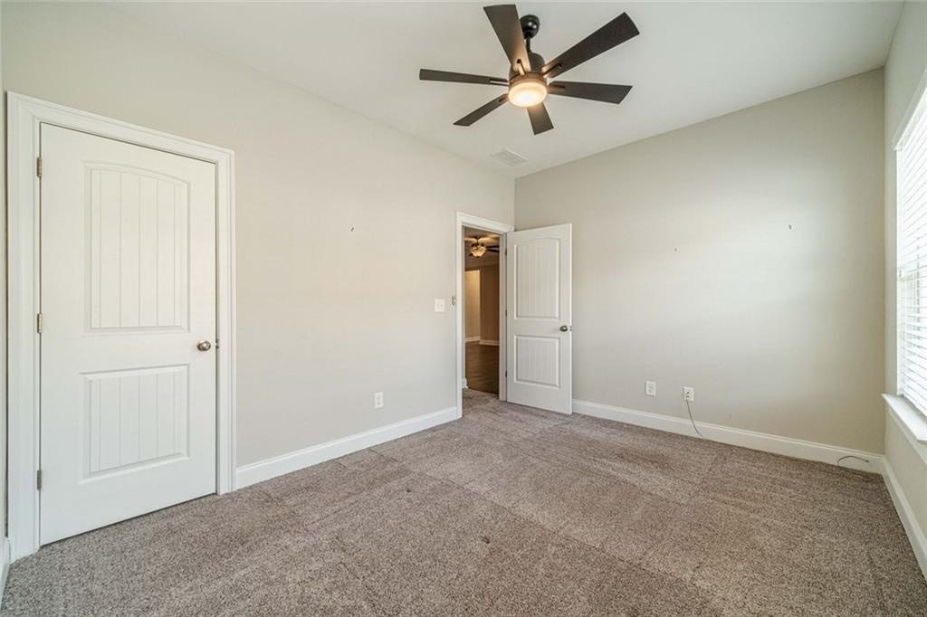 347 Villa Park Circle Stone Mountain, GA 30087 - Photo 20 of 25 an empty room with closet and fan