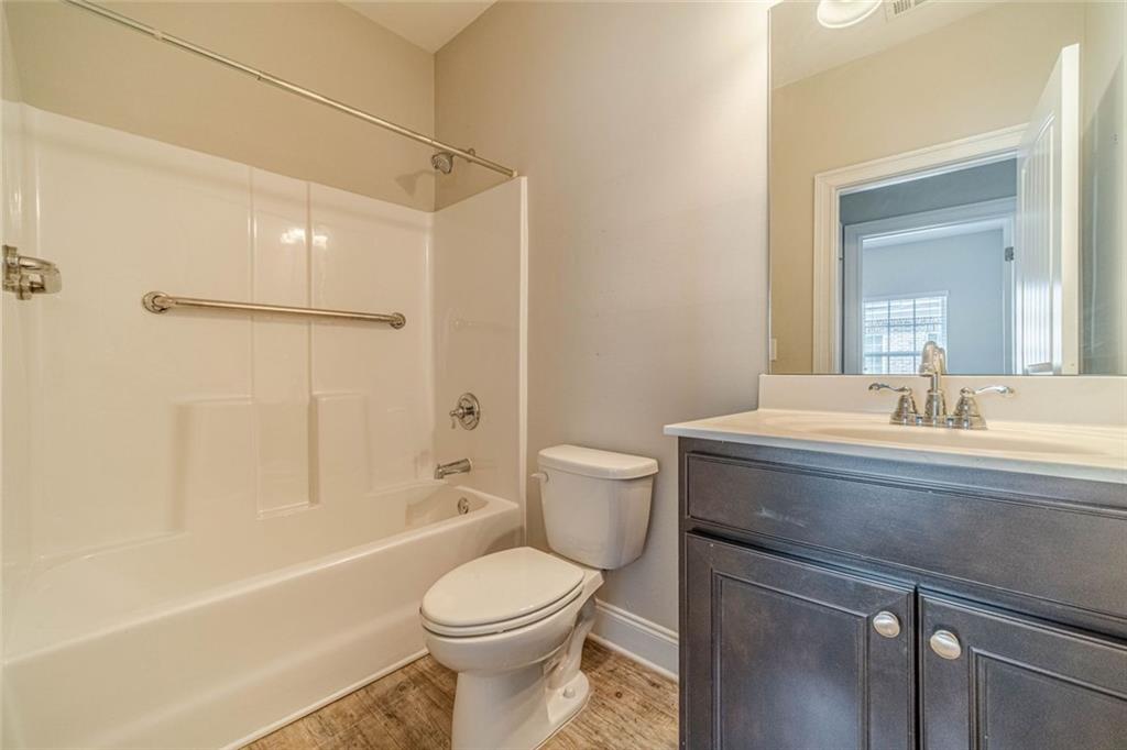 347 Villa Park Circle Stone Mountain, GA 30087 - Photo 21 of 25 a bathroom with a sink a toilet and shower