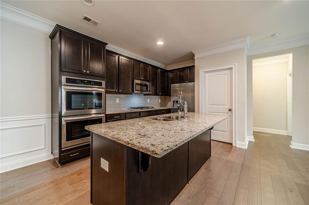 347 Villa Park Circle Stone Mountain, GA 30087 - Photo 4 of 25 a kitchen with a refrigerator and a sink